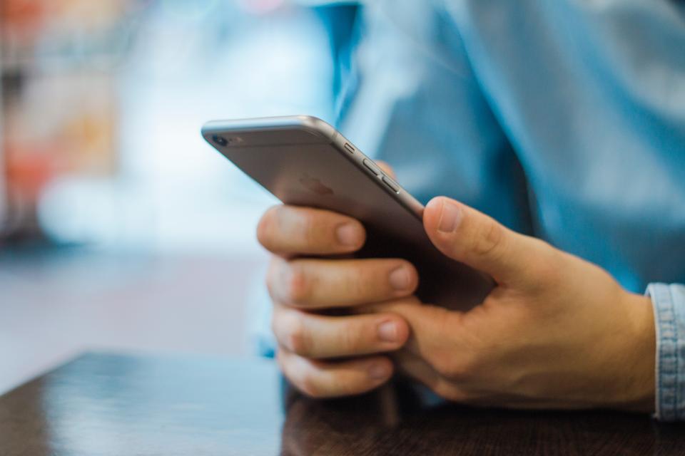 A hand holding a phone